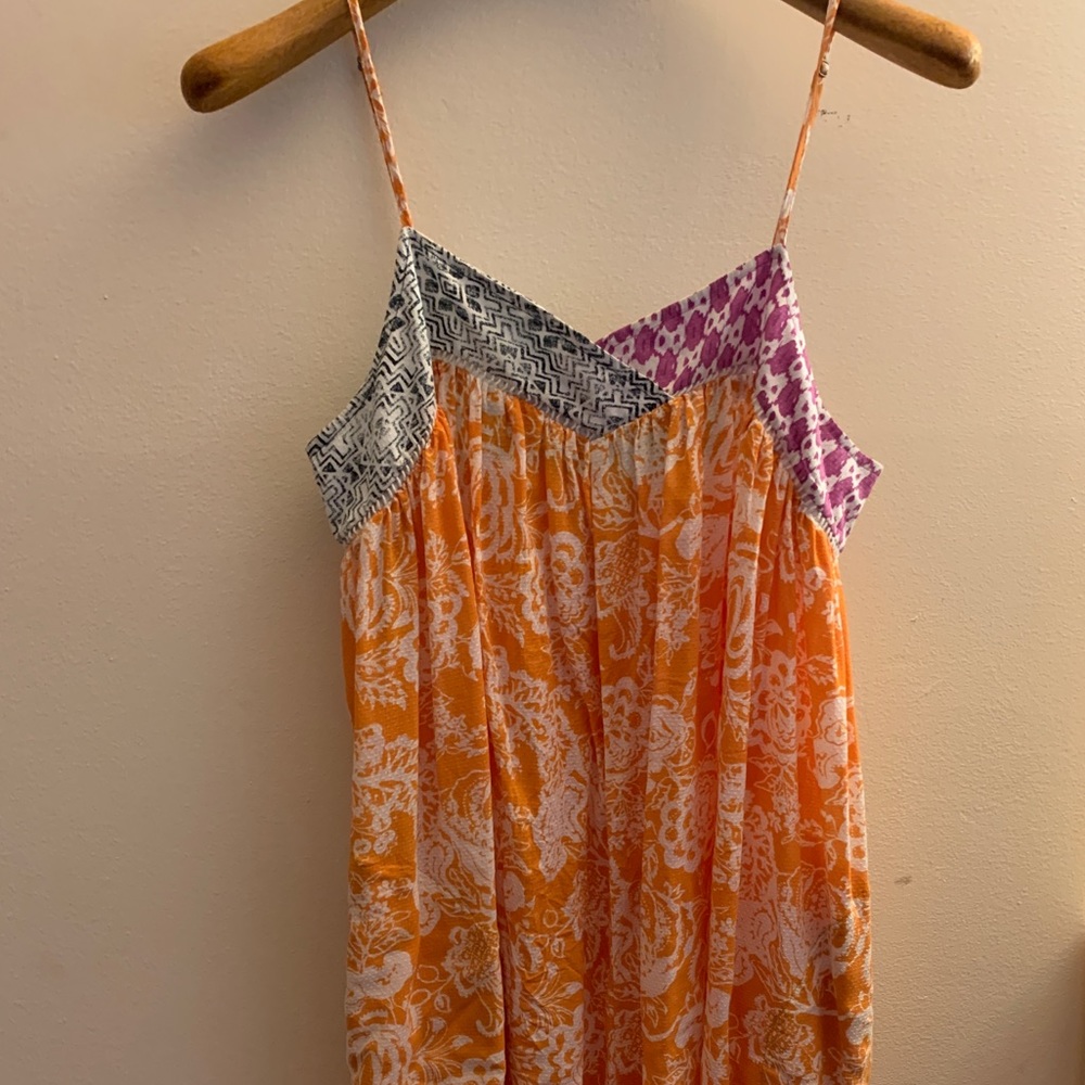 Pretty orange colored romper with pockets from Anthropologie.